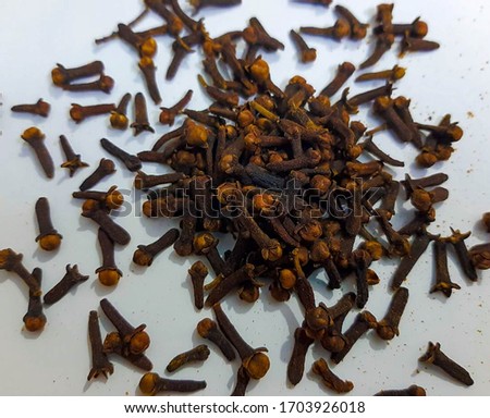 Pictures of spices such as black pepper and cloves arranged by a design