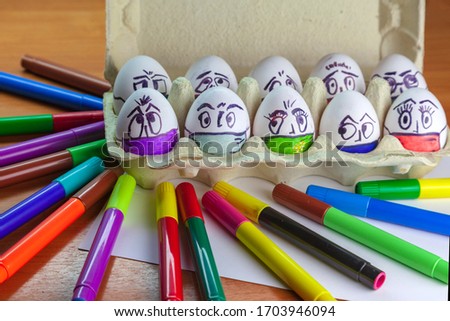 Easter eggs on the theme of coronavirus, painted funny masked faces on Easter eggs, decorated for Easter,