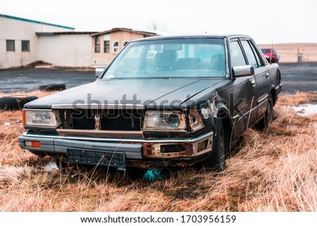 Old car in the junkyard Royalty-Free Stock Photo #1703956159
