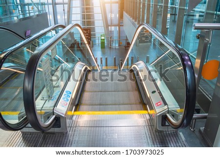 Neon illuminated metal excavator with rubber handrails stairs view descent down to floor Royalty-Free Stock Photo #1703973025
