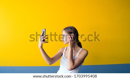 Portrait of beautiful young woman take a photo with mobile phone