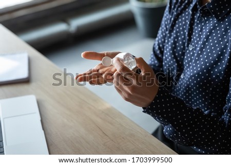 Close up of female employee disinfect hands with antibacterial liquid protect from COVID-19 at workplace, woman worker cleanse use sanitizer in office, healthcare, coronavirus pandemic concept Royalty-Free Stock Photo #1703999500