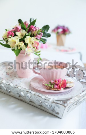 Pink set decor cup and plate. Pink flower decor breakfast table. Tea time on white background.