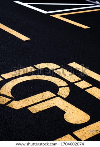 handicap road sign symmetrical street photography with lines with yellow and black 