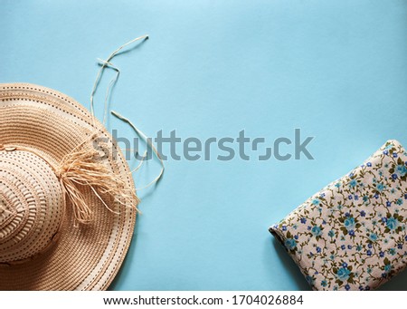 Flat lay picture of summer vacation accessories, including straw hat and craft ethnic purse. Summer holiday vacation, travel, tourism concept. Tropical top view background.