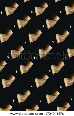 Pattern. Gold toilet paper with a crown on a black background. A concept on the topic of coronavirus and pandemic.