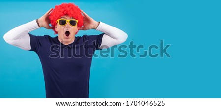 man with funny wig isolated on color background