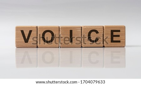 word VOICE made on wooden cubes on white grey glossy background