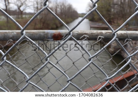 Rusty chain link fence on the river