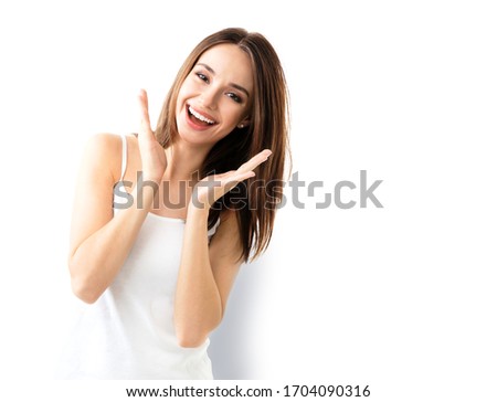 Young brunette lovely woman showing smile, in casual smart clothing, isolated against white background. Caucasian model in emoshions and optimistic, positive, happy feeling concept. 