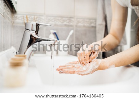 Antiseptic hand washing procedure with soap and water.Decontamination steps of good hand hygiene practice.Cleaning routine for hands,palms,fingers.Infectious disease prevention/protection Royalty-Free Stock Photo #1704130405