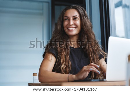 Young businesswoman manage business from home on remote, freelancer using laptop sit kitchen table on self-quarantine, work over personal growth, apply for online courses to learn new skills Royalty-Free Stock Photo #1704131167