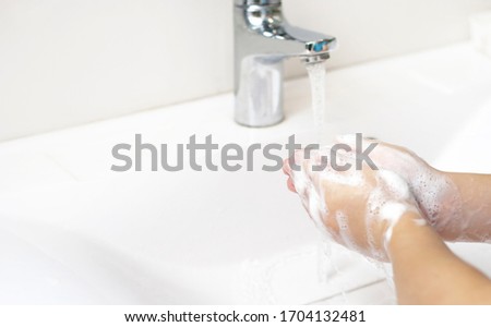 Kid wash hands with much soap carefully. hygiene and flu covid pandemic prevention. Helth care for children lifestyle closeup picture. Water and soap. Free copy space for text