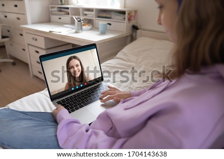 Young girls best friends chatting by videocall webcam laptop enjoy conversation from home. During self-isolation quarantine due to coronavirus people stay at home communication use modern tech concept Royalty-Free Stock Photo #1704143638
