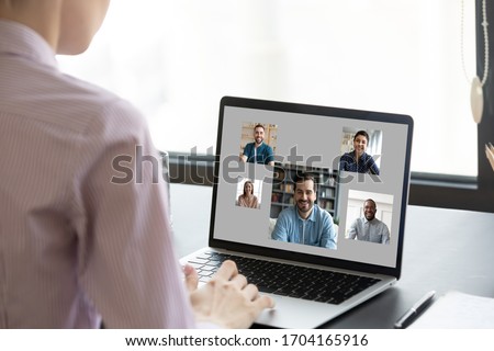 View over woman shoulder pc screen, diverse people faces on laptop monitor. Employer choose vacancy candidate after distant job interview, virtual chat communication, video call app, e-date services Royalty-Free Stock Photo #1704165916