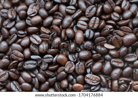 Coffee beans Coffee scattered on the table, roasted top view, natural sunlight falling on coffee, close up, background.