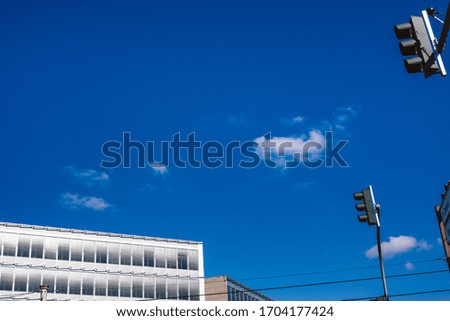Modern Office Building with Traffic Light on blue Sky