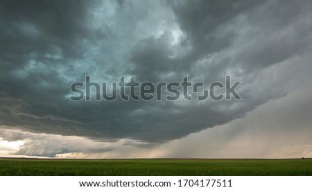 Severe storm over the plains of Colorado during tornado warning as it forms in the distance.