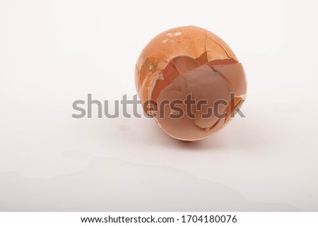 The shell of a broken chicken egg on a white background. Close up.