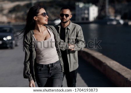 fashionable love story by sea. woman with boyfriend having fun outdoors. fashion couple in love