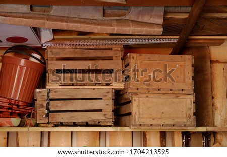 wooden boxes on a shelf in the barn. wood background. copy space.