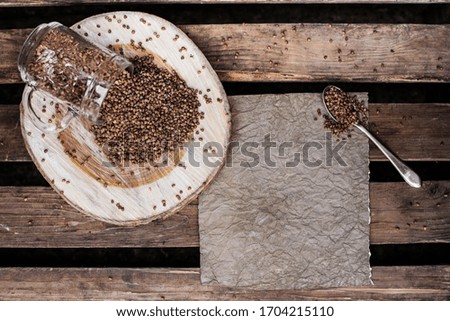 buckwheat porridge on a dark wooden background and a sheet of paper for text