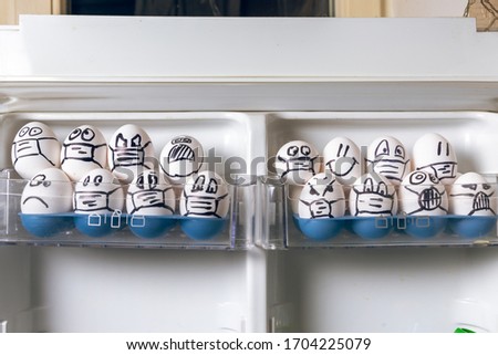 violation of quarantine rules concept. close up of diverse chicken easter eggs with doodle emotional faces wearing medical masks crowding in fridge door