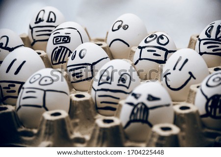 coronavirus quarantine easter concept. close up of diverse chicken easter eggs with doodle emotional faces wearing medical masks on white background