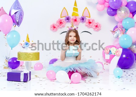 Unicorn Girl holding gift box. Idea for decorating unicorn style birthday party. Unicorn decoration for festival party girl.