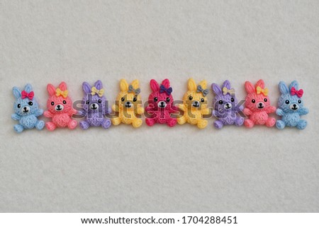 Funny multi-colored toy rabbits on a white background