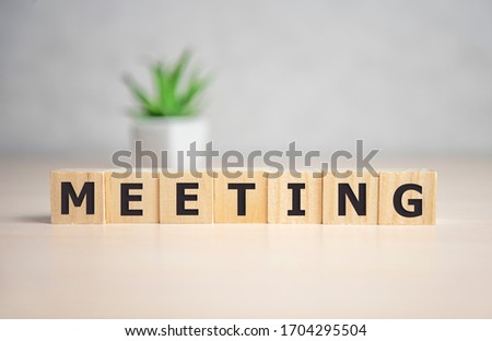 MEETING word written on wood block. MEETING text on wooden table for your desing, concept.