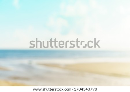 Blur summer bokeh beach with sun light and blue sky background.