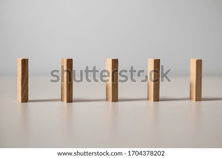 Social Distancing concept. Wooden blocks toy placed on white background with wide spacing.