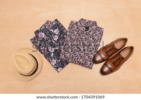 Men's spring fashion clothes with accessories on wooden background