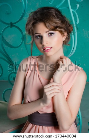 Portrait of a beautiful young girl in a cocktail dress. Beautiful decorations on the background.