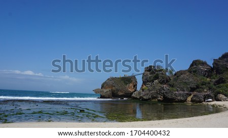 The Scenery of the Beach with Huge Rocks with White Sand on the Siung Beach, Indonesia