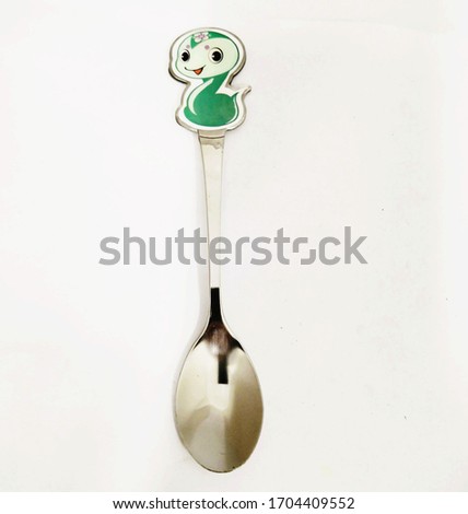 Dessert spoon on the dinning table as an cartoon on top to make it more beautiful. 