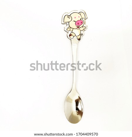 Dessert spoon on the dinning table as an cartoon on top to make it more beautiful. 