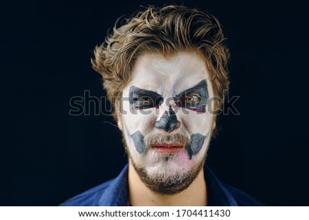 Make-up man of the day of death on Halloween, evil suspicious glance. Copy Space