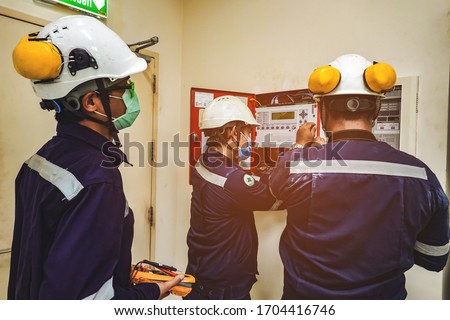 Electrician inspects the power control to find the abnormal condition of transformer by using thermo scanner ot the  industrail. Royalty-Free Stock Photo #1704416746