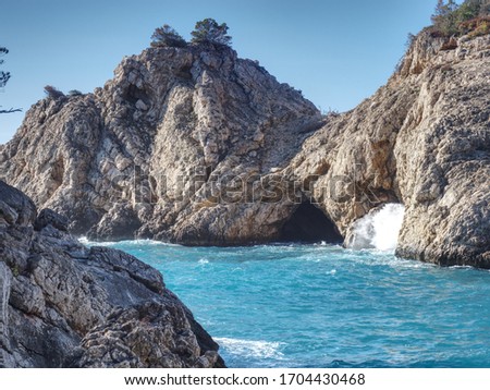 Peguera village, Mallorca island. Sea wave still  breaks on beach rocks landscape. Sea waves crash and splash on rocks