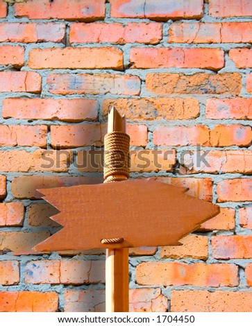 Go There (Handmade Wooden Signpost Over Grunge Brick Wall)