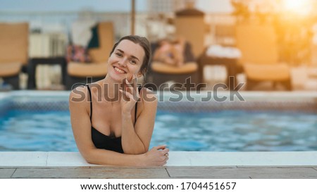 Girl after swimming posing in the pool.