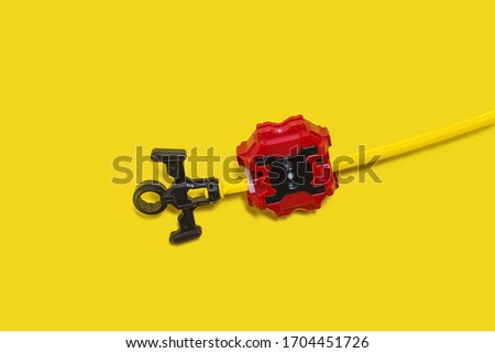 set of popular kid toys over yellow background. Ring, launcher, gyroscope