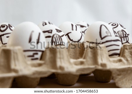 concept of quarantine easter. close up of set of Easter smiled egg surrounded by eggs with drawn medical masks and emotions. copy space