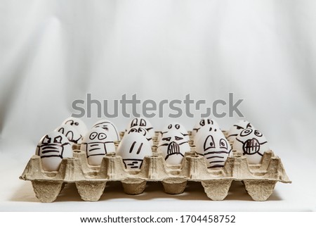 set of Easter eggs with drawn medical masks and emotions 