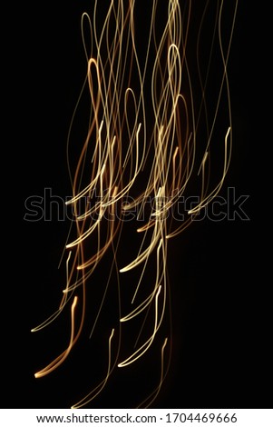 Yellow abstract lines and waves on a black background
