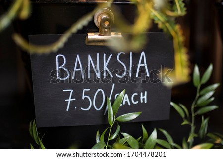 Banksia bouquet wrapped in the beige craft paper for sale in a store