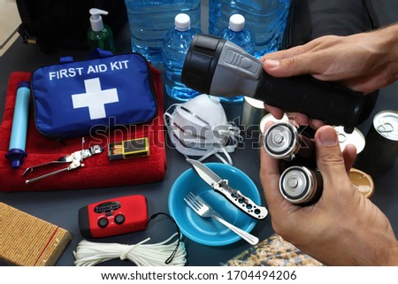 Disaster management includes preparing a disaster kit that can be contained in a go bag.These items should include a first aid kit,food,water,flashlight,radio,sleeping bag.Items that will help you. Royalty-Free Stock Photo #1704494206