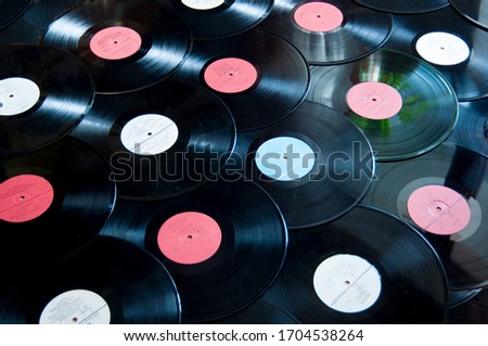 A few vinyl records. Music background from a heap of vinyl vintage records. Abstract music colorful border, made of vintage vinyl records. Music background of vinyl records. 